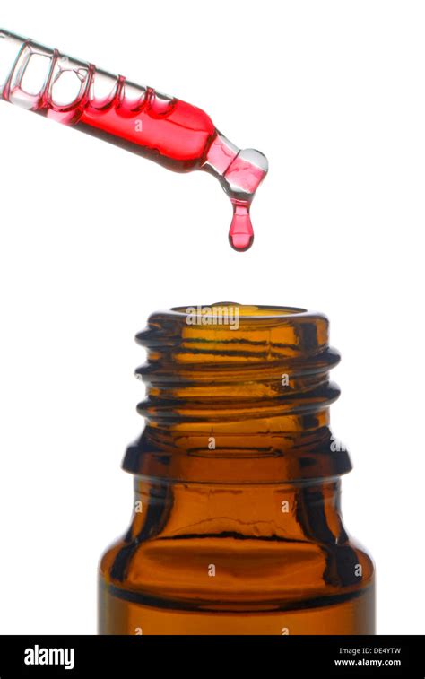 A pipette filled with red liquid sitting on top of a glass jar. AI 